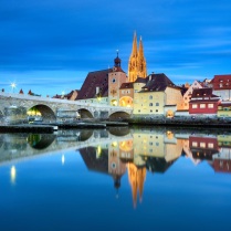 Germany, Bavaria, Upper Palatinate, Regensburg - The Stone Bridge, St. Peter's Church and the Old Town of Regensburg reflecting on the Danube river